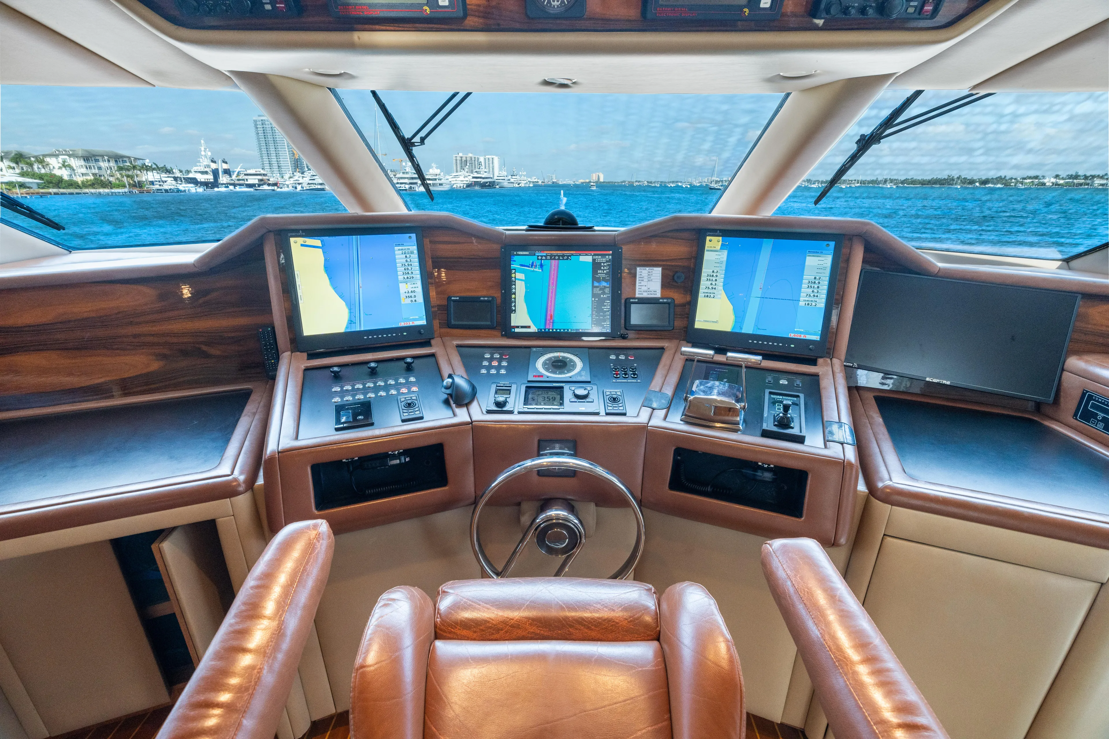 Crown Jewel Yacht Photos Pics Luxurious 1996 Broward 96 Raised Pilothouse MY yacht cockpit with navigation screens and leather seating.