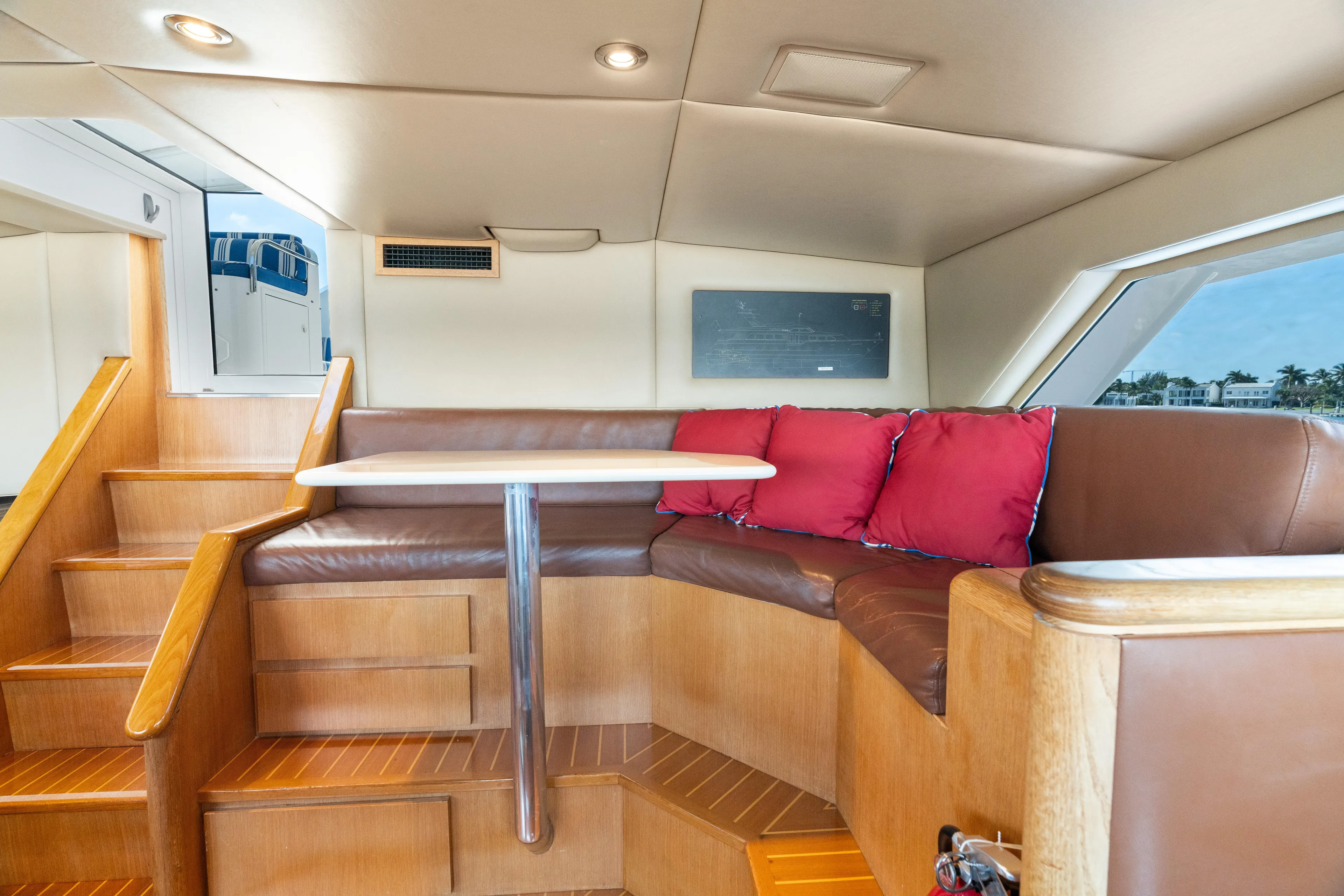 Crown Jewel Yacht Photos Pics Interior of 1996 Broward 96 Raised Pilothouse MY yacht with leather seating and wooden accents.