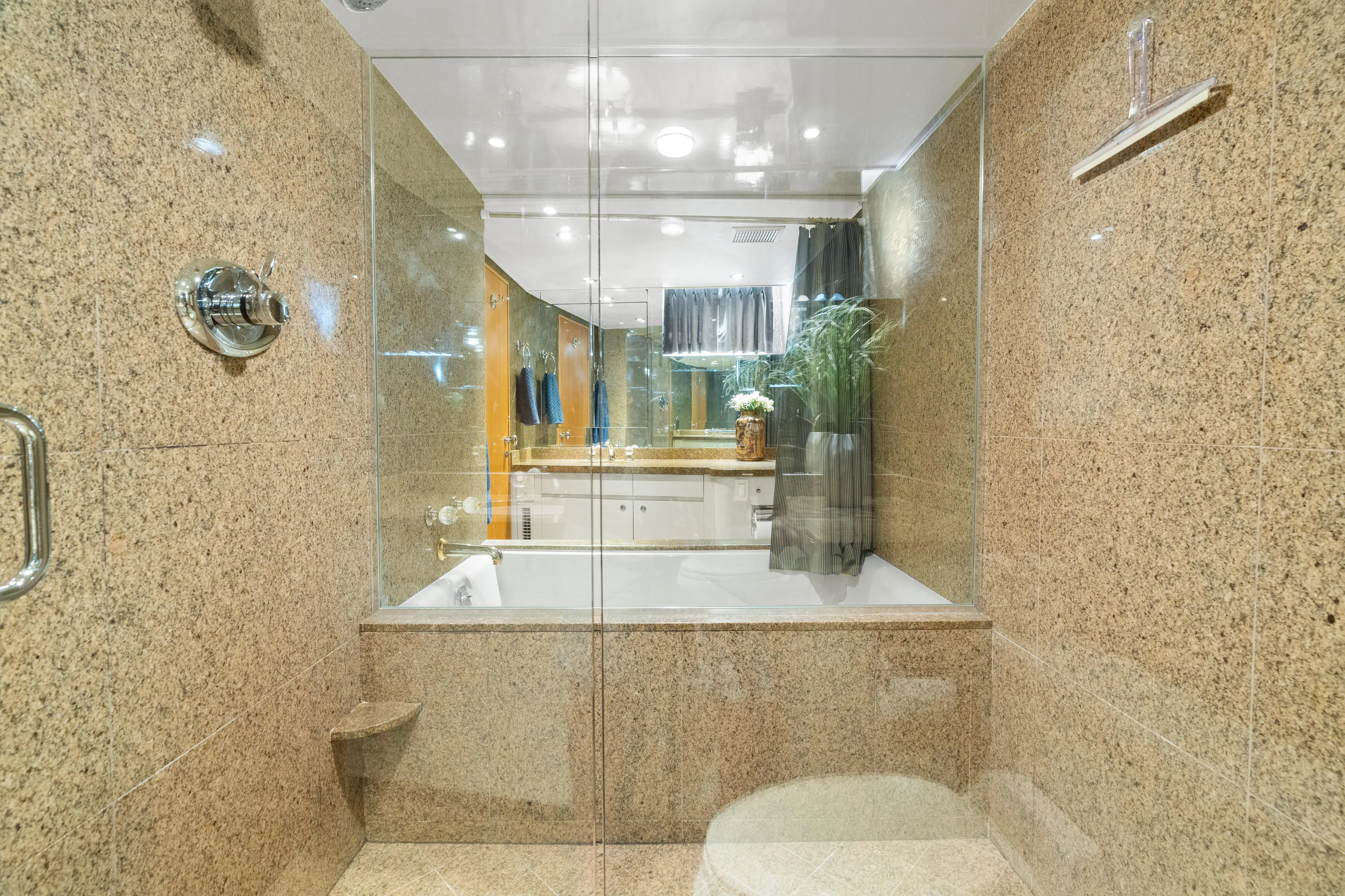 Crown Jewel Yacht Photos Pics Luxurious bathroom with granite walls in 1996 Broward 96 Raised Pilothouse MY yacht.