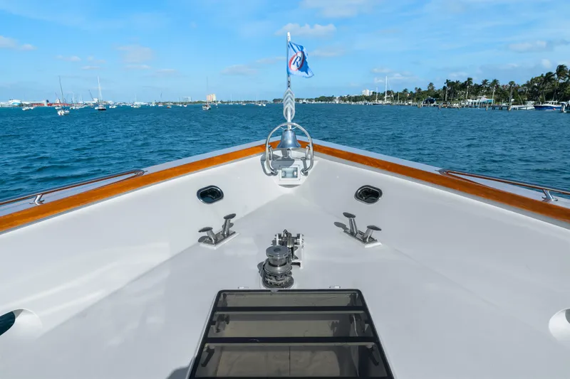 Crown Jewel Yacht Photos Pics Bow view of 1996 Broward 96 Raised Pilothouse MY yacht on calm waters.