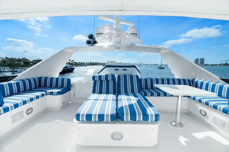 Crown Jewel Yacht Photos Pics Luxurious 1996 Broward 96 Raised Pilothouse MY yacht with striped seating on deck.