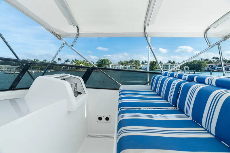 Crown Jewel Yacht Photos Pics Luxury yacht interior with blue striped seating, Broward 96 Raised Pilothouse MY, 1996 model.