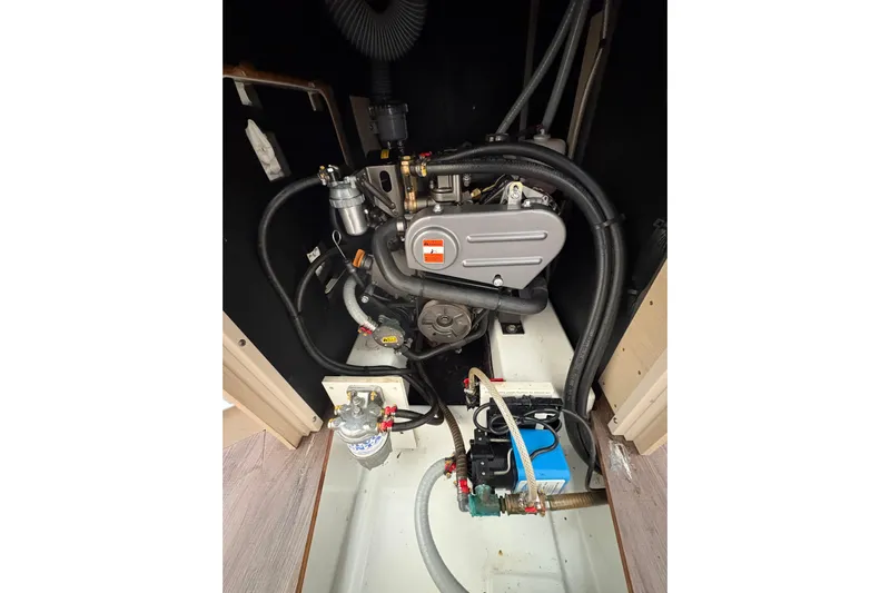  Yacht Photos Pics Engine compartment of 2021 Beneteau Oceanis 38.1 sailboat, showcasing mechanical components.