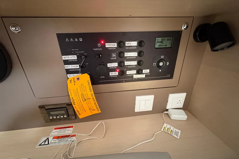  Yacht Photos Pics Control panel of a 2021 Beneteau Oceanis 38.1 sailboat with caution tags.