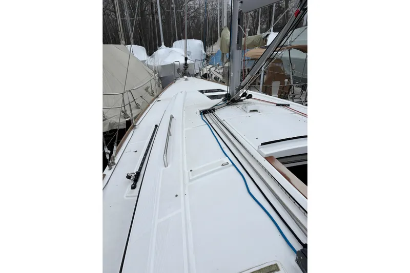  Yacht Photos Pics 2021 Beneteau Oceanis 38.1 sailboat deck with rigging and covered boats in background.