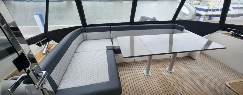  Yacht Photos Pics Luxurious seating area on a 2017 Galeon 550 Fly yacht with a sleek table.