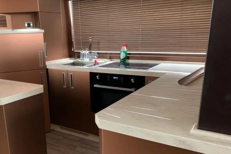  Yacht Photos Pics Modern kitchen interior on 2017 Galeon 550 Fly yacht with sleek cabinetry and appliances.