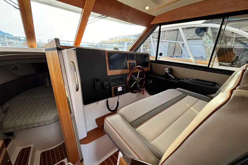  Yacht Photos Pics 2022 Cutwater C-32 CB boat interior with helm, seating, and cabin view.
