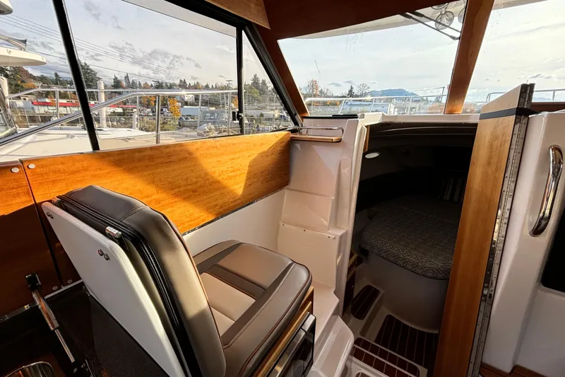  Yacht Photos Pics Interior of 2022 Cutwater C-32 CB boat, featuring helm seat and cabin entrance.