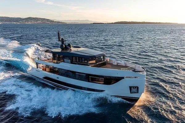  Yacht Photos Pics 2024 Arcadia Yachts A96 cruising on open water at sunset.