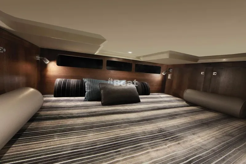 Libra Yacht Photos Pics Interior cabin of 2016 Monterey 360 Sport Coupe with striped bedding and cushions.