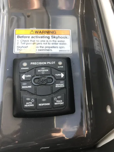 Libra Yacht Photos Pics Control panel of a 2016 Monterey 360 Sport Coupe with warning label and buttons.