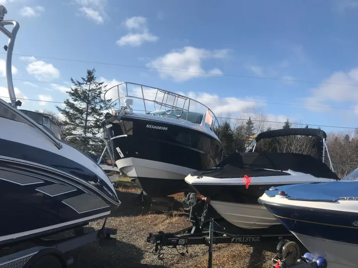 Libra Yacht Photos Pics Boats including a 2016 Monterey 360 Sport Coupe in a storage yard under a clear sky.