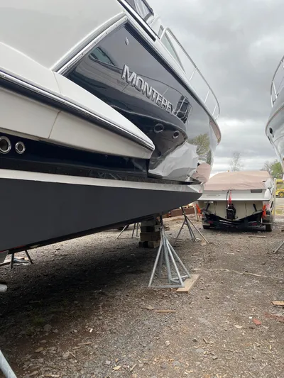Libra Yacht Photos Pics 2016 Monterey 360 Sport Coupe boat on dry dock, overcast sky.