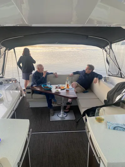 Libra Yacht Photos Pics People relaxing on a 2016 Monterey 360 Sport Coupe yacht, enjoying drinks and conversation.