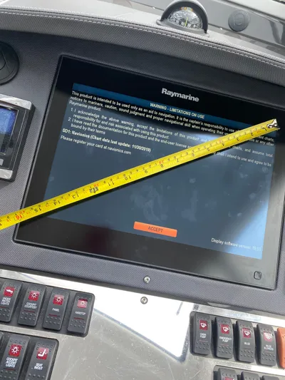 Libra Yacht Photos Pics Control panel of a 2016 Monterey 360 Sport Coupe with a Raymarine display and measuring tape.