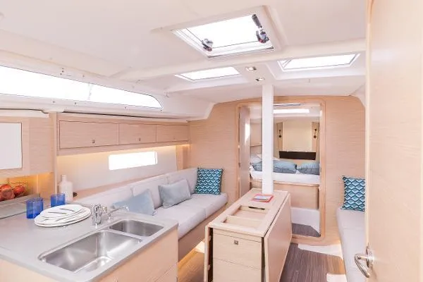 In Stock #74 Yacht Photos Pics 2024 Dufour 37 yacht interior with modern kitchen and cozy seating area.