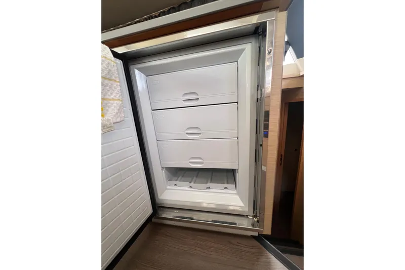 B&b Yachts Yacht Photos Pics Open refrigerator with three drawers inside a 2019 Fountaine Pajot SABA 50 yacht.