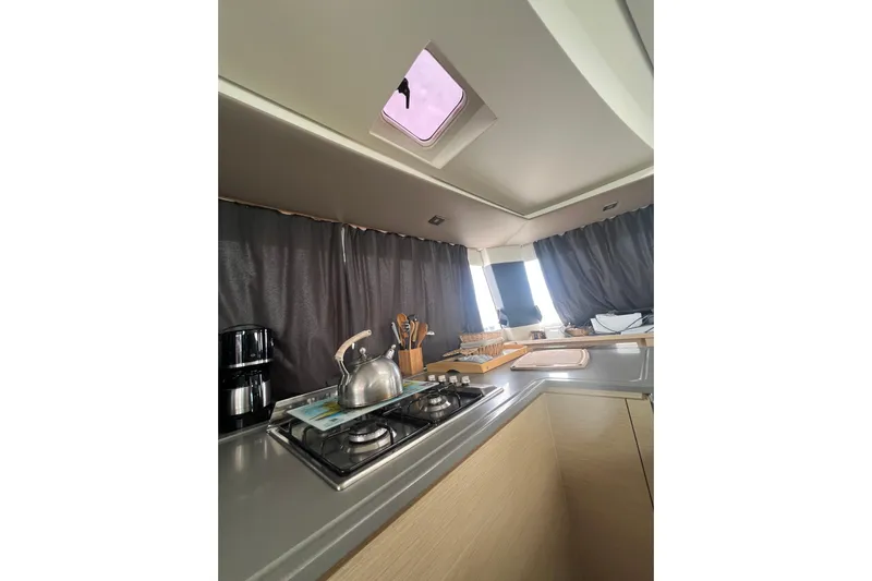 B&b Yachts Yacht Photos Pics Modern kitchen interior of 2019 Fountaine Pajot SABA 50 catamaran with stove and utensils.