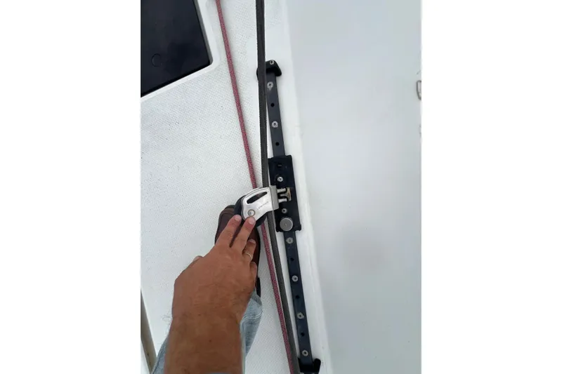 B&b Yachts Yacht Photos Pics Hand adjusting sail track on 2019 Fountaine Pajot SABA 50 catamaran deck.