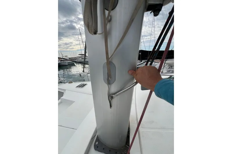 B&b Yachts Yacht Photos Pics Hand adjusting mast on 2019 Fountaine Pajot SABA 50 catamaran at marina.