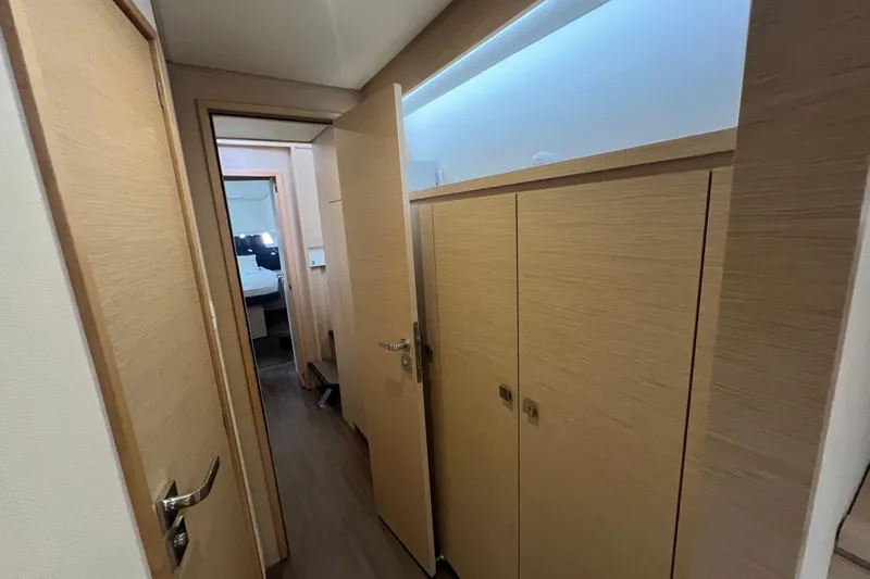 B&b Yachts Yacht Photos Pics Interior hallway of 2019 Fountaine Pajot SABA 50 catamaran, featuring wooden doors and modern design.