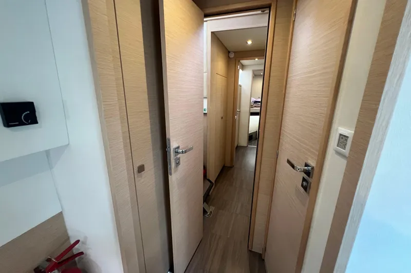 B&b Yachts Yacht Photos Pics Interior hallway of 2019 Fountaine Pajot SABA 50 catamaran, featuring wooden doors and modern design.