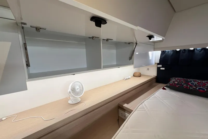 B&b Yachts Yacht Photos Pics Interior cabin of 2019 Fountaine Pajot SABA 50 yacht, featuring storage and bedding.