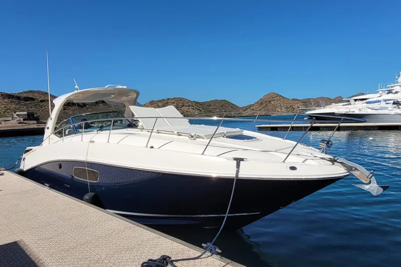  Yacht Photos Pics 2011 Sea Ray 370 Sundancer docked in a scenic marina with clear blue skies.