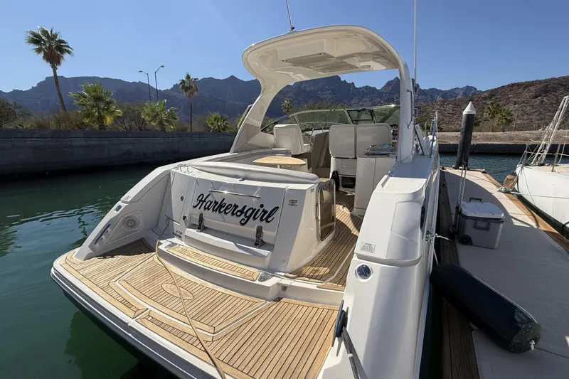  Yacht Photos Pics 2011 Sea Ray 370 Sundancer yacht docked, featuring spacious deck and scenic mountain backdrop.