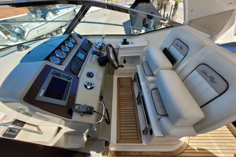  Yacht Photos Pics Cockpit of 2011 Sea Ray 370 Sundancer with dual seats and navigation controls.