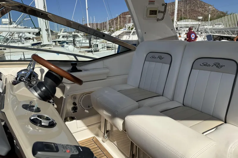  Yacht Photos Pics 2011 Sea Ray 370 Sundancer helm with white leather seats and wooden steering wheel.