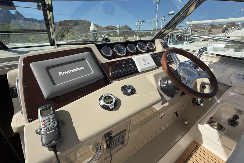  Yacht Photos Pics 2011 Sea Ray 370 Sundancer helm with Raymarine navigation system and wooden steering wheel.