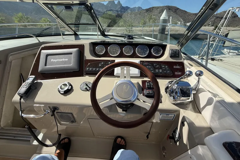 Yacht Photos Pics Cockpit view of 2011 Sea Ray 370 Sundancer with steering wheel and navigation equipment.