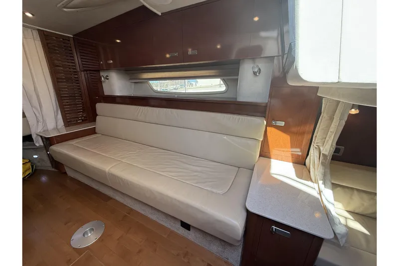  Yacht Photos Pics Luxurious interior of 2011 Sea Ray 370 Sundancer with cream leather seating and wooden accents.