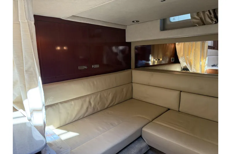  Yacht Photos Pics Interior of 2011 Sea Ray 370 Sundancer with beige leather seating and wood paneling.