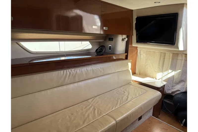  Yacht Photos Pics Luxurious interior of 2011 Sea Ray 370 Sundancer with leather seating and mounted TV.