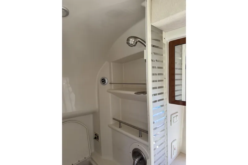  Yacht Photos Pics Bathroom interior of 2011 Sea Ray 370 Sundancer yacht, featuring shower and mirror.