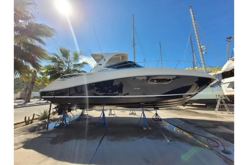  Yacht Photos Pics 2011 Sea Ray 370 Sundancer yacht on stands, sunny day, palm trees in background.