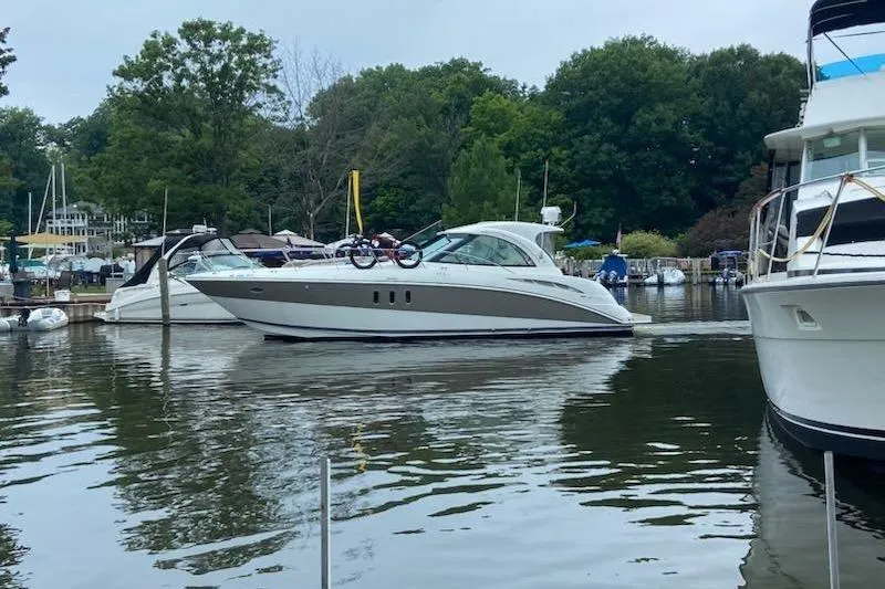  Yacht Photos Pics 2008 Cruisers Yachts 390 Sports Coupe docked in a serene marina setting.