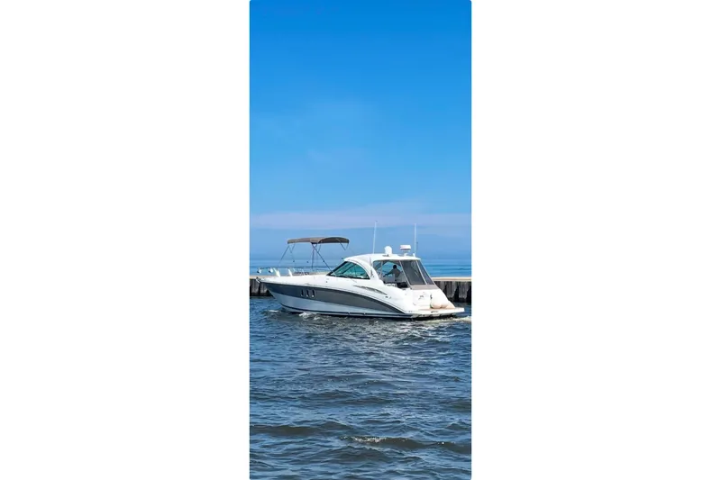  Yacht Photos Pics 2008 Cruisers Yachts 390 Sports Coupe on calm water under clear blue sky.