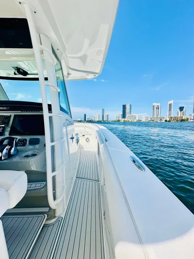  Yacht Photos Pics 2016 Boston Whaler 350 Outrage on water, city skyline in background, clear blue sky.