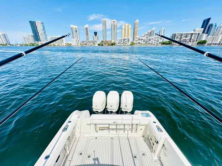  Yacht Photos Pics Boston Whaler 350 Outrage 2016 on water with city skyline in background.