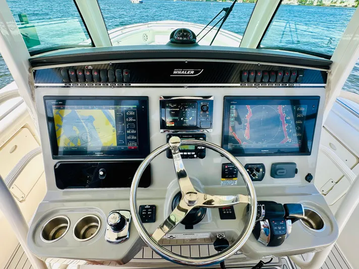  Yacht Photos Pics 2016 Boston Whaler 350 Outrage helm with dual navigation screens and steering wheel.