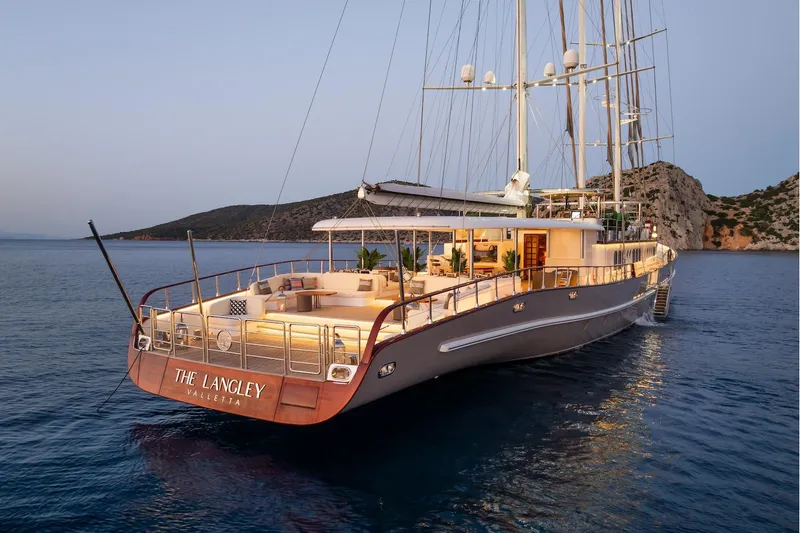 The Langley Yacht Photos Pics Luxurious 2009 Aegean Yacht 3 Mast Schooner at sunset, anchored in serene waters.