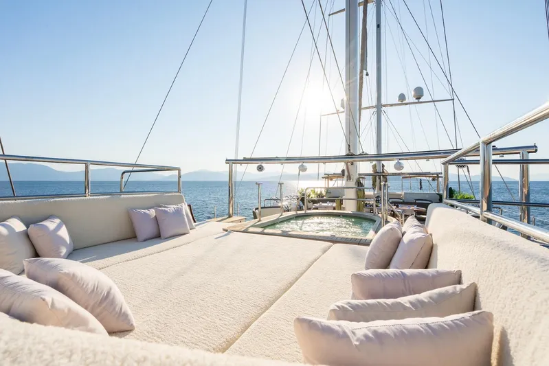 The Langley Yacht Photos Pics Luxurious deck of 2009 Aegean Yacht 3 Mast Schooner with sunlit seating and ocean view.