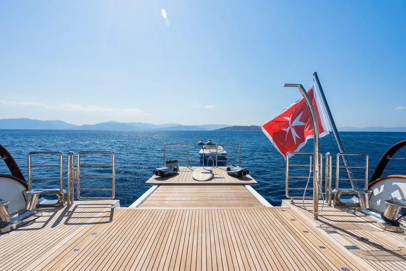 The Langley Yacht Photos Pics Aegean Yacht 3 Mast Schooner 2009, deck view with ocean and flag.