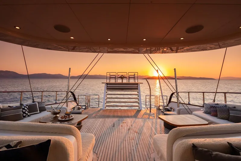 The Langley Yacht Photos Pics Luxurious Aegean Yacht 3 Mast Schooner deck at sunset, 2009 model, serene ocean view.