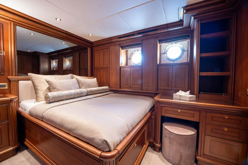 The Langley Yacht Photos Pics Luxurious wooden cabin interior on 2009 Aegean Yacht 3 Mast Schooner, featuring elegant bedding and portholes.