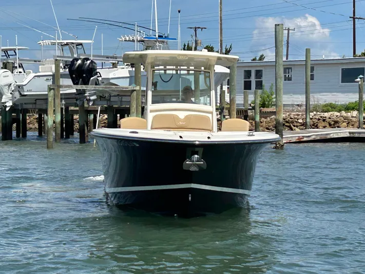  Yacht Photos Pics 2018 Scout 275 LXF boat on water near docks, clear sky background.